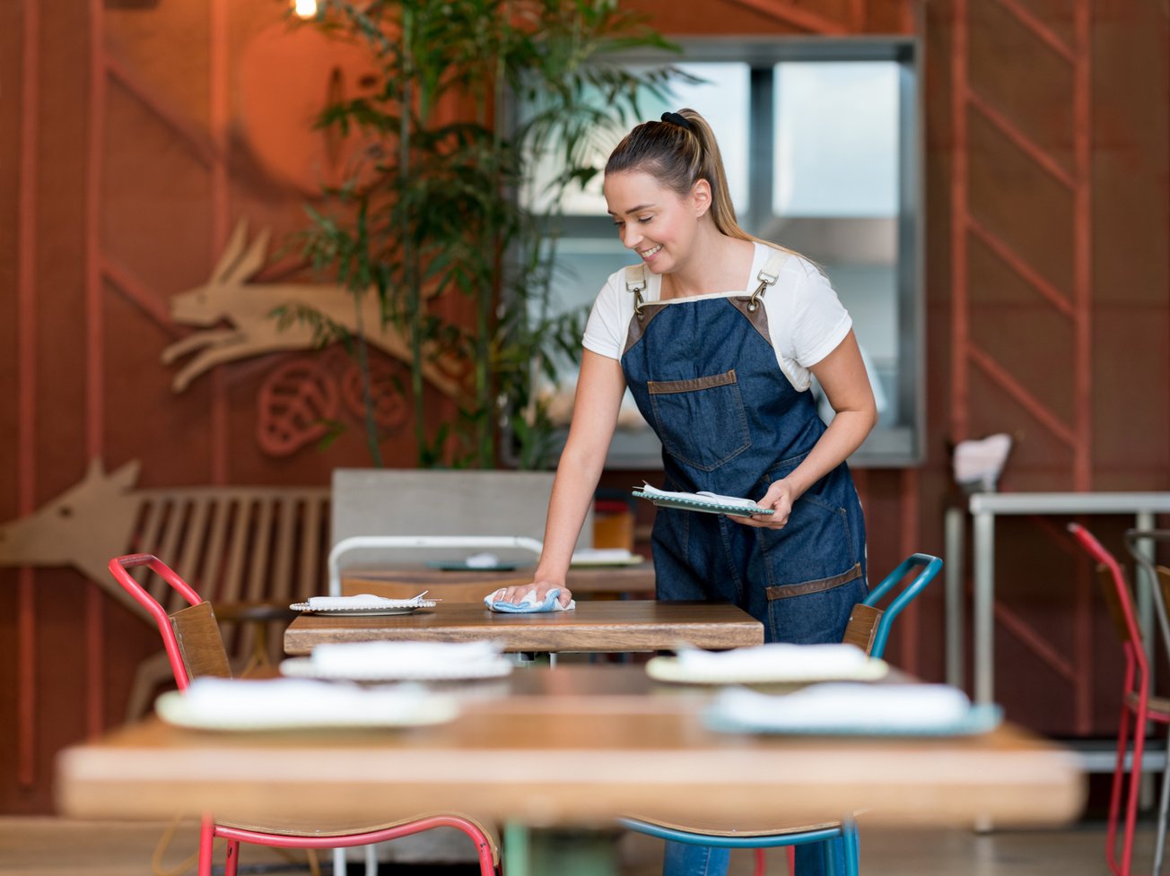 Waitress cleaning the tables at a restaurant