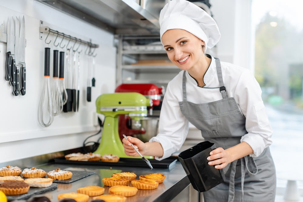 Pastry Chef Glazing Little Cakes